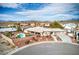 Aerial view of property with desert landscaping, an in-ground pool, and lush trees at 3540 E Burgundy Dr, Pahrump, NV 89048