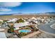 Aerial view of property showing desert landscape and the in-ground pool at 3540 E Burgundy Dr, Pahrump, NV 89048