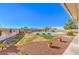 Backyard with kidney-shaped pool and desert landscaping at 3540 E Burgundy Dr, Pahrump, NV 89048