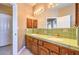 Bathroom with double vanity, green tile, and large mirror at 3540 E Burgundy Dr, Pahrump, NV 89048