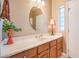 Bathroom with vanity, oval mirror, and window at 3540 E Burgundy Dr, Pahrump, NV 89048