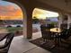 Covered patio with seating area, overlooking a pool and stunning sunset at 3540 E Burgundy Dr, Pahrump, NV 89048