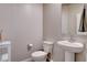 Powder room featuring a pedestal sink, toilet, and neutral color scheme at 3812 Seyfert Ave, North Las Vegas, NV 89084