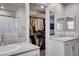 Bright bathroom featuring a walk-in closet, granite countertops, and double sinks with stylish fixtures at 3812 Seyfert Ave, North Las Vegas, NV 89084