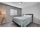 Bedroom with a comfortable bed, modern lamp, and window providing plenty of natural light at 3812 Seyfert Ave, North Las Vegas, NV 89084