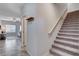 Entryway featuring tile flooring, coat hooks, and carpeted stairs at 3812 Seyfert Ave, North Las Vegas, NV 89084