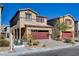 Two-story stucco home with a red garage door and desert landscaping provides curb appeal at 3812 Seyfert Ave, North Las Vegas, NV 89084