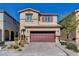 Traditional two-story home showcasing desert landscaping, a red garage door, and neutral stucco at 3812 Seyfert Ave, North Las Vegas, NV 89084