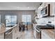 Bright kitchen with stainless steel appliances, granite countertops, and an eat-in dining area at 3812 Seyfert Ave, North Las Vegas, NV 89084