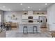 Modern kitchen with stainless steel appliances, kitchen island with seating, and an open layout to the living area at 3812 Seyfert Ave, North Las Vegas, NV 89084