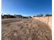 Large vacant lot with a view of the house and block wall at 390 Peaceful St, Las Vegas, NV 89110