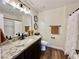 Modern bathroom with granite countertop, dark vanity, and white subway tile shower at 390 Peaceful St, Las Vegas, NV 89110