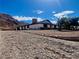 Single story home with mountain views and a gravel driveway at 390 Peaceful St, Las Vegas, NV 89110