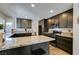 Renovated kitchen with granite countertops and dark cabinets at 3981 Ebro Way, Las Vegas, NV 89103