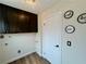 Laundry room with dark cabinets and wood-look floors at 3981 Ebro Way, Las Vegas, NV 89103