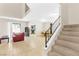 Open concept living room with tiled flooring, leading to stairs, kitchen, and outside at 4248 Tolkien Ave, Las Vegas, NV 89115