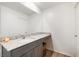 Bathroom with granite countertop, gray cabinets, and a large mirror at 4904 Siglo St, North Las Vegas, NV 89031