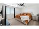 Spacious bedroom with ceiling fan, large bed, and plenty of natural light at 4904 Siglo St, North Las Vegas, NV 89031