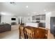 Open dining area with wooden table and chairs, adjacent to kitchen and living room at 4904 Siglo St, North Las Vegas, NV 89031