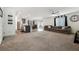 Open concept living room and kitchen with grey sectional sofa and granite countertops at 4904 Siglo St, North Las Vegas, NV 89031