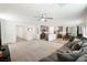 Open concept living room and kitchen with grey sectional sofa and granite countertops at 4904 Siglo St, North Las Vegas, NV 89031