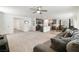 Open concept living room and kitchen with grey sectional sofa and granite countertops at 4904 Siglo St, North Las Vegas, NV 89031