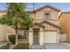 Two-story house with beige exterior, attached garage, and landscaping at 531 Dairy Creek Ave, Las Vegas, NV 89183