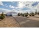 Single-story home with attached garage and landscaped yard at 5521 Money St, Pahrump, NV 89048