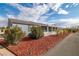 Side view of the house showcasing additional landscaping and a covered patio area at 5521 Money St, Pahrump, NV 89048