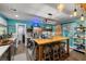 Modern kitchen with teal walls, an island, and stainless steel appliances at 5521 Money St, Pahrump, NV 89048