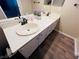 Bright bathroom with dual sinks and wood-look flooring at 5710 E Tropicana Ave # 2122, Las Vegas, NV 89122