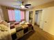 This bedroom features sliding closet doors, a ceiling fan and pink curtains that enhance the room's comfort and function at 5710 E Tropicana Ave # 2122, Las Vegas, NV 89122