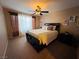 Spacious bedroom with queen bed, ceiling fan and large window at 5710 E Tropicana Ave # 2122, Las Vegas, NV 89122