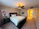 Bright bedroom with queen bed, ceiling fan, and ensuite bathroom at 5710 E Tropicana Ave # 2122, Las Vegas, NV 89122