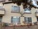 Exterior view of condo building displays the stucco finish, window placement, and gas meter locations at 5710 E Tropicana Ave # 2122, Las Vegas, NV 89122