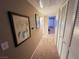 Bright hallway with carpet, leading to bedrooms and closets at 5710 E Tropicana Ave # 2122, Las Vegas, NV 89122