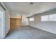 Large bedroom with wood accent wall, carpet, and access to bathroom and backyard at 607 Sierra Ln, Henderson, NV 89002