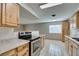 Modern kitchen with wood cabinets, granite counters, and stainless steel appliances at 607 Sierra Ln, Henderson, NV 89002