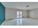 Bright living room featuring tiled floors and access to backyard at 607 Sierra Ln, Henderson, NV 89002