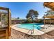 Relaxing pool area with wooden enclosure and surrounding trees at 607 Sierra Ln, Henderson, NV 89002