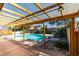 Inviting pool area with pergola, brick patio, and lush landscaping at 607 Sierra Ln, Henderson, NV 89002