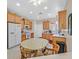 Kitchen with light wood cabinets, white appliances, and a breakfast nook at 6075 Jutland Ave, Las Vegas, NV 89122