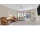 Living room with two armchairs, sofa, and glass-top coffee table at 6075 Jutland Ave, Las Vegas, NV 89122