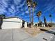 House exterior showcasing a white garage door and palm trees in the front yard at 6552 Boxwood Ln, Las Vegas, NV 89103