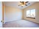 Neutral bedroom with a ceiling fan and large window offering neighborhood views at 6752 Lookout Lodge Ln # 1, North Las Vegas, NV 89084