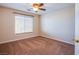 Cozy bedroom featuring a window with blinds and carpet at 6752 Lookout Lodge Ln # 1, North Las Vegas, NV 89084