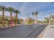 Secured gated entrance to the community, featuring palm trees and landscaped surroundings at 6752 Lookout Lodge Ln # 1, North Las Vegas, NV 89084