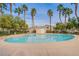 Refreshing community pool with clear blue water, surrounded by palm trees and well-maintained landscaping at 6752 Lookout Lodge Ln # 1, North Las Vegas, NV 89084