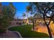 Landscaped backyard with covered patio, artificial turf, and gazebo at 7220 Elderly Ave, Las Vegas, NV 89131