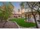 Landscaped backyard with artificial turf and covered patio at 7220 Elderly Ave, Las Vegas, NV 89131